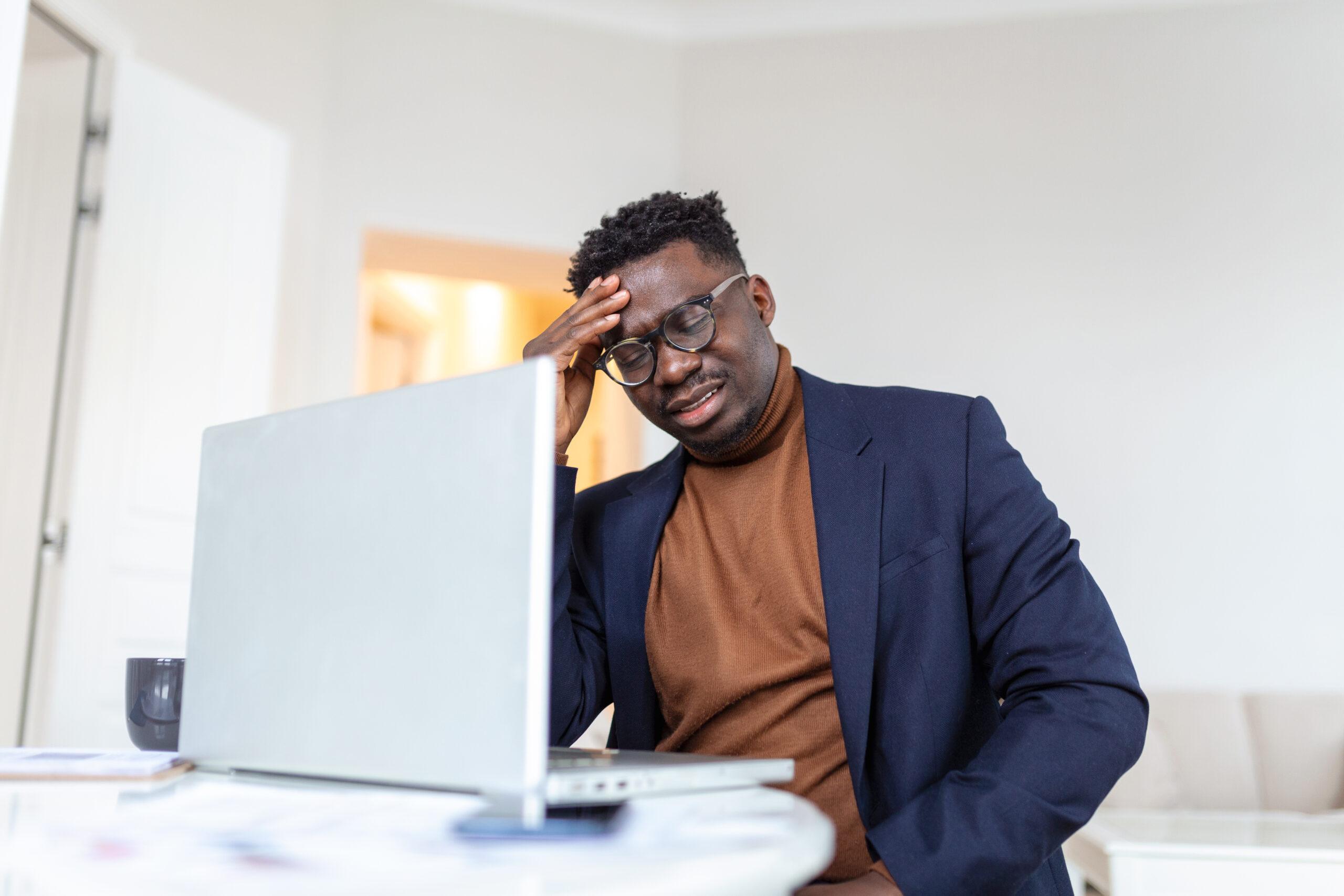 A stressed man after making salary Overpayments and Underpayments to Staff